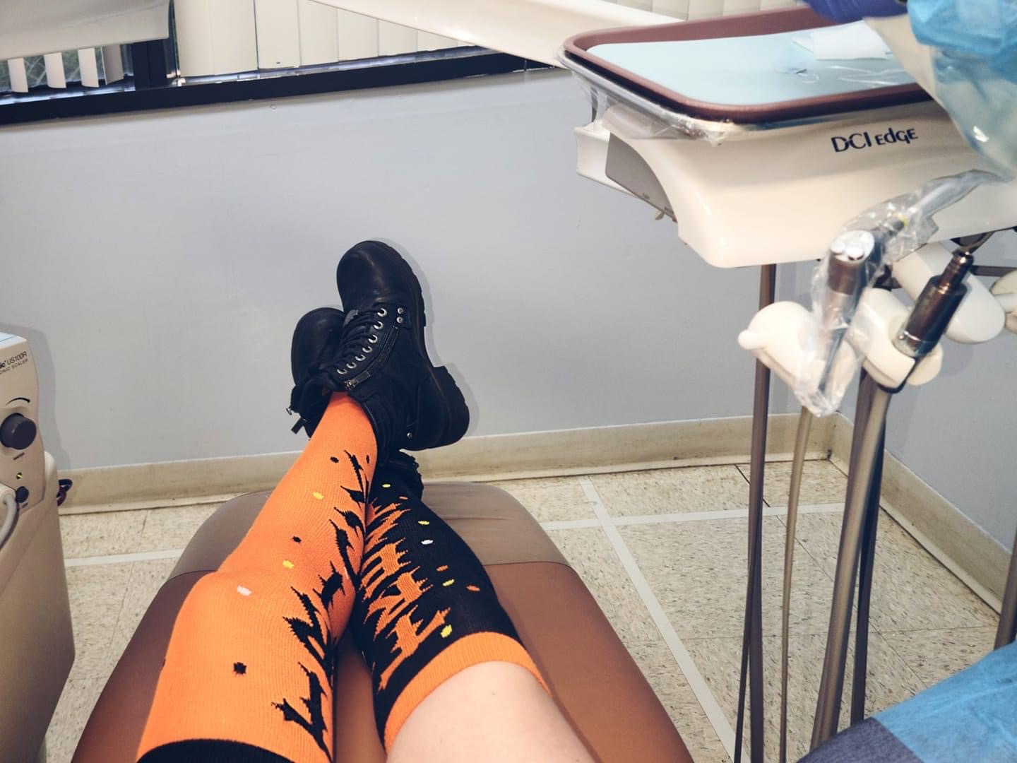 Katie in orange halloween socks and black military boots